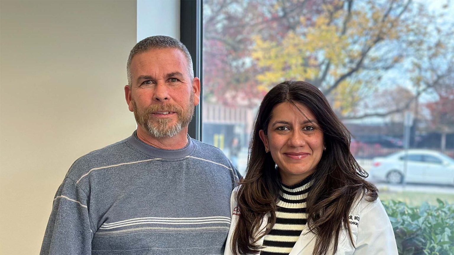 Kevin and Dr. Godil standing together at Cooper and Inspira office.