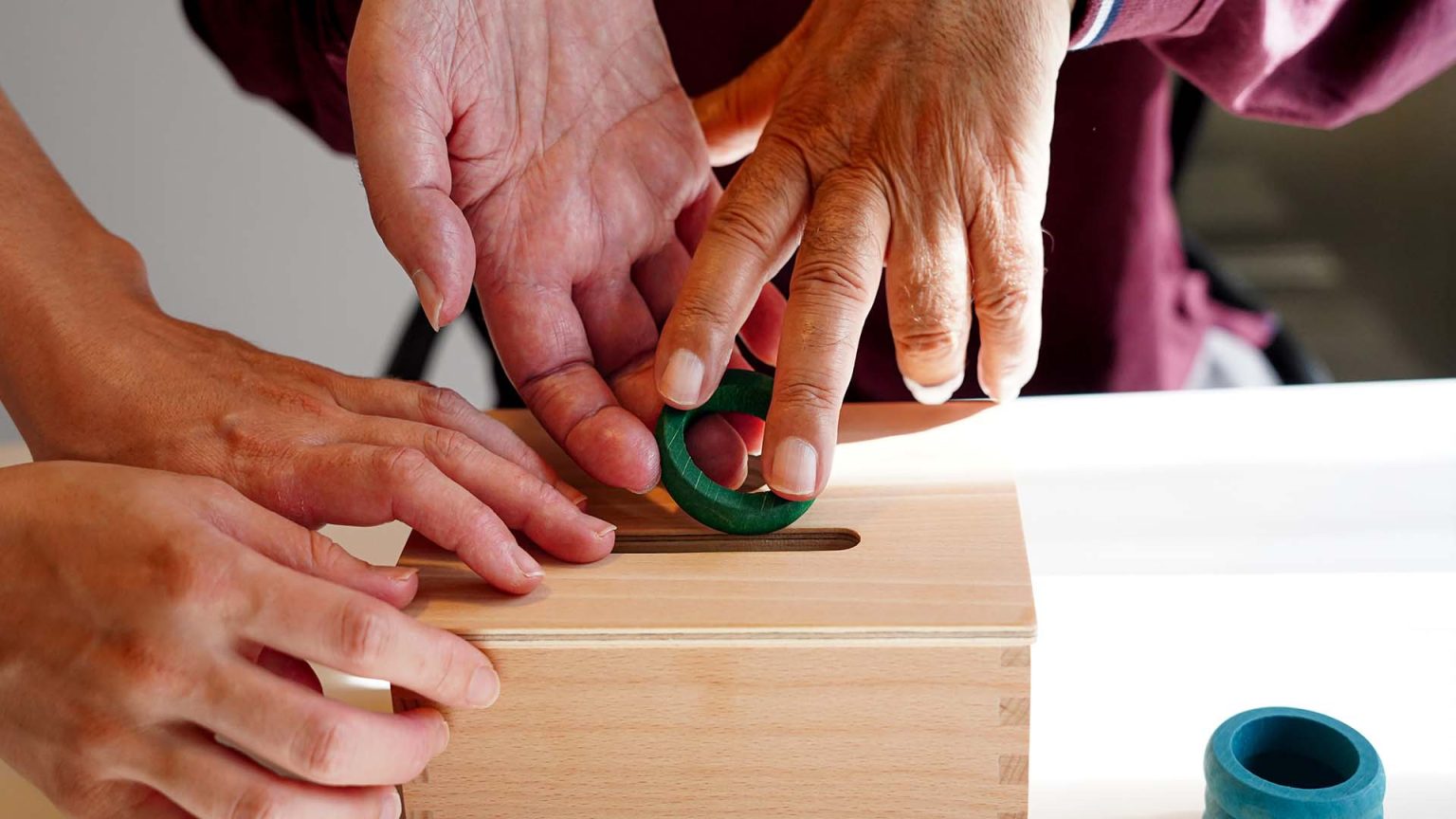 ALS patient assisted with fine motor skill exercise.