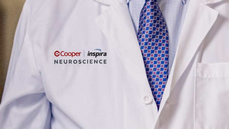 Physician's lab coat with Cooper and Inspira Neuroscience on chest.